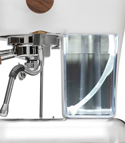 Close-up of a Ascaso Dream PID Automatic Home Espresso Machine - Cloud White with a clear container for water or milk.